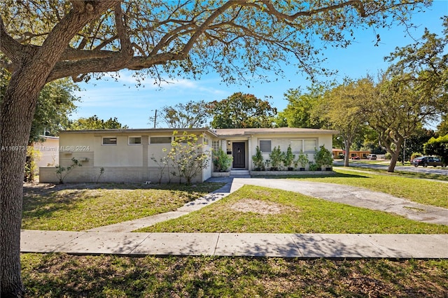 ranch-style home with a front lawn