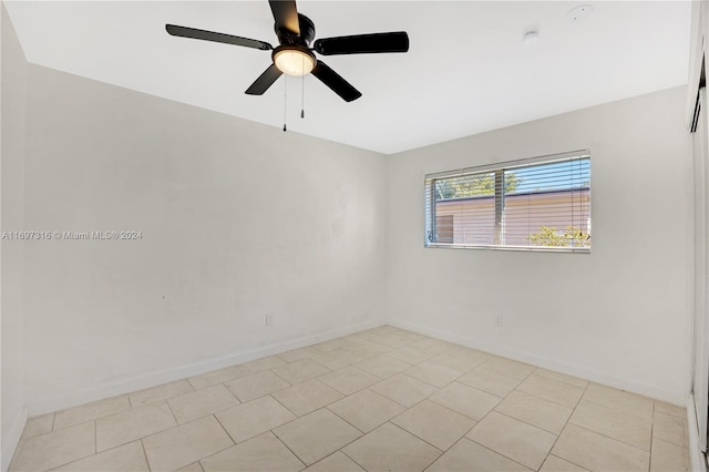 unfurnished room with ceiling fan and light tile patterned floors