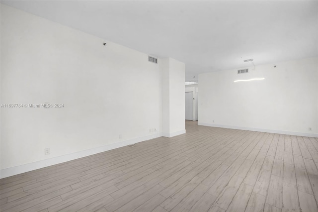 empty room with light hardwood / wood-style flooring