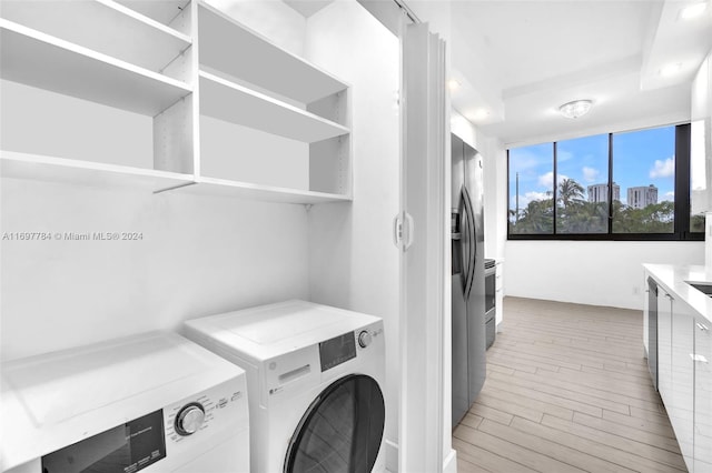 laundry area featuring washer and dryer and wood-type flooring