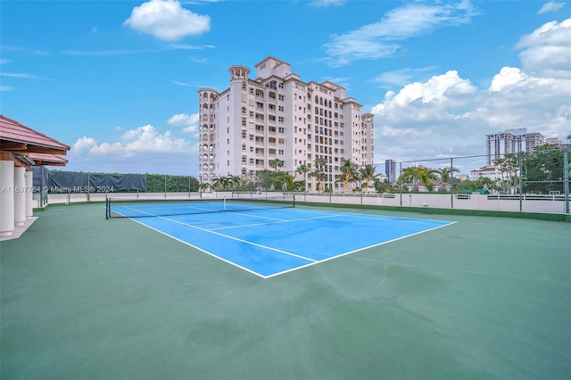 view of tennis court with basketball hoop