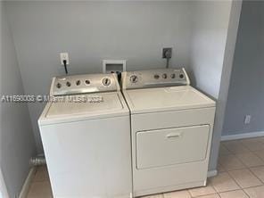 laundry room with light tile patterned floors and washer and dryer