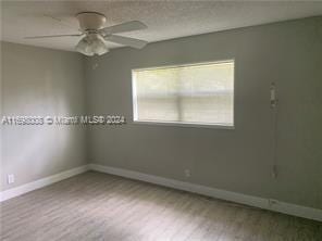 empty room featuring light hardwood / wood-style flooring and ceiling fan