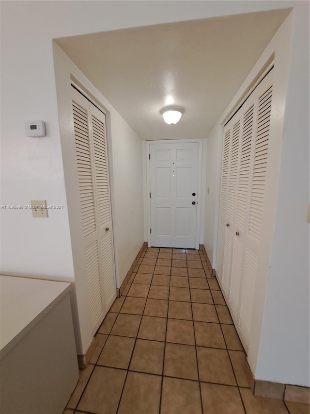 corridor with tile patterned flooring