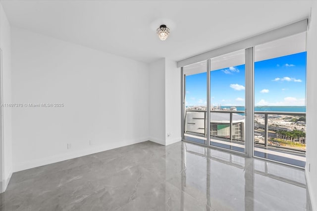 empty room with a water view and a wall of windows