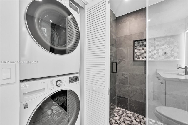 clothes washing area with sink and stacked washer and clothes dryer