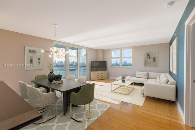 dining area with a chandelier and light hardwood / wood-style flooring