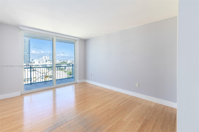 unfurnished room with light hardwood / wood-style flooring