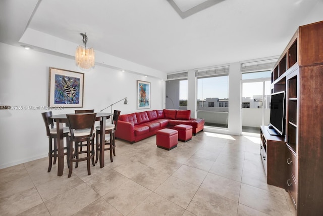 tiled living room featuring a chandelier