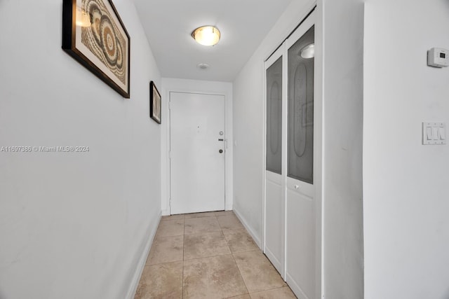 corridor with light tile patterned floors