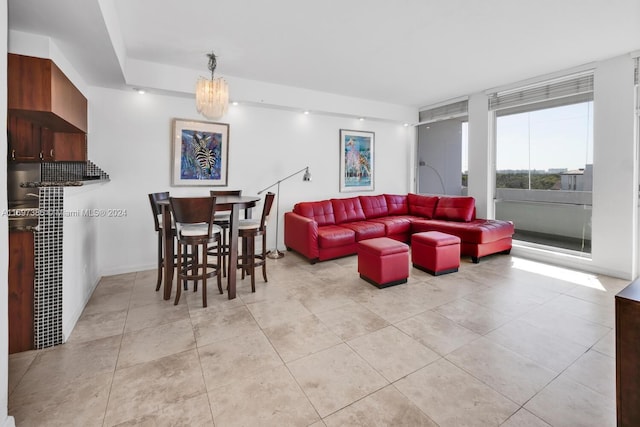 tiled living room with a chandelier