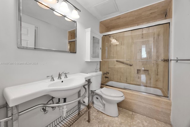 bathroom with tile patterned floors, toilet, and combined bath / shower with glass door