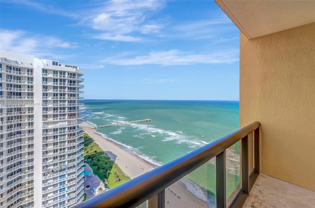 balcony with a beach view and a water view