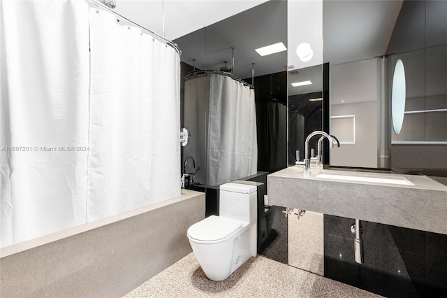 full bathroom featuring toilet, shower / bathtub combination with curtain, and sink