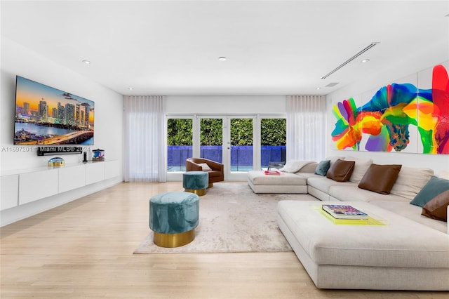 living room featuring light wood-type flooring and french doors