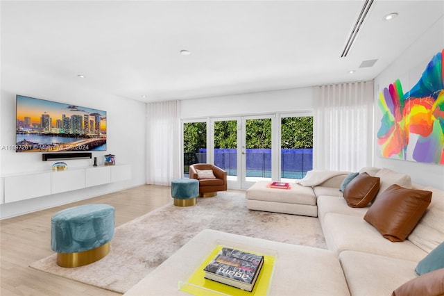 living room featuring french doors and hardwood / wood-style flooring