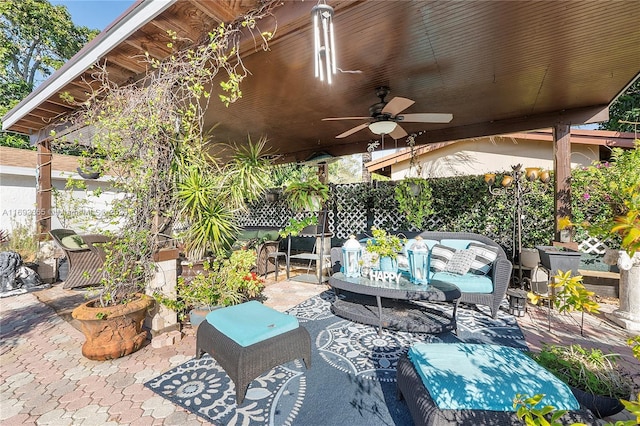 view of patio / terrace with ceiling fan and an outdoor living space