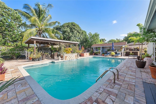 view of pool with pool water feature and a patio area