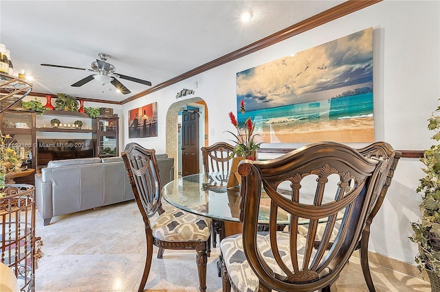 dining space featuring ceiling fan and ornamental molding