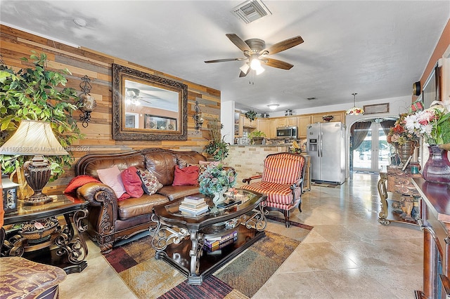 living room with french doors and wooden walls