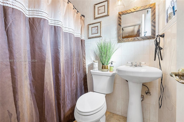 bathroom with toilet, tile walls, and walk in shower