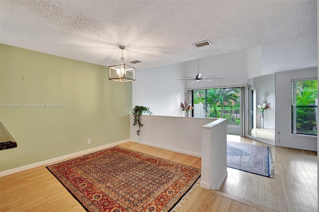 93 NE 17th Ct Unit 93, Fort Lauderdale, FL 33305 - empty room featuring light wood-type flooring, a textured ceiling, and a chandelier