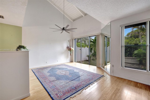 interior space with a textured ceiling, light wood-type flooring, plenty of natural light, and ceiling fan