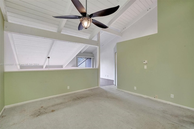 carpeted empty room featuring vaulted ceiling with beams, ceiling fan, and wooden ceiling