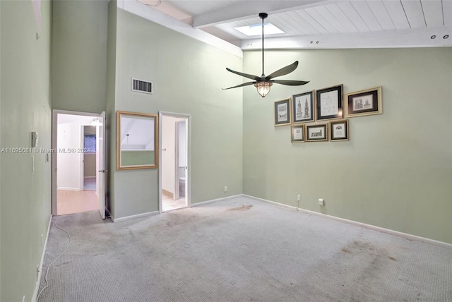 interior space with vaulted ceiling with beams and ceiling fan