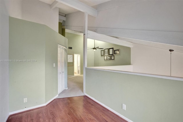 hallway with hardwood / wood-style floors and lofted ceiling with beams