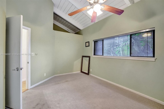 empty room with light carpet, vaulted ceiling with beams, ceiling fan, and wood ceiling