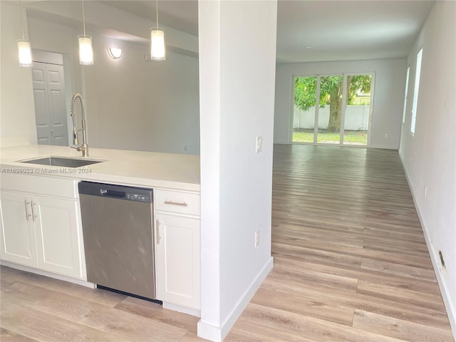 kitchen with white cabinetry, dishwasher, sink, pendant lighting, and light wood-type flooring