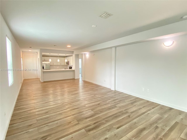 unfurnished living room with light wood-type flooring