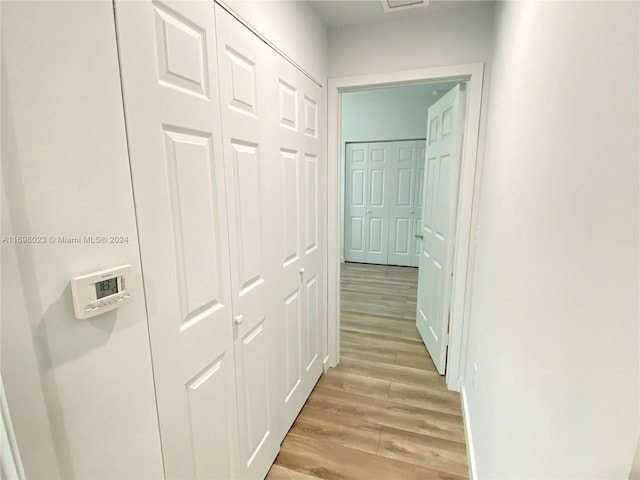 corridor with light hardwood / wood-style flooring