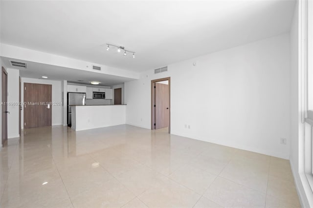 unfurnished living room with light tile patterned floors