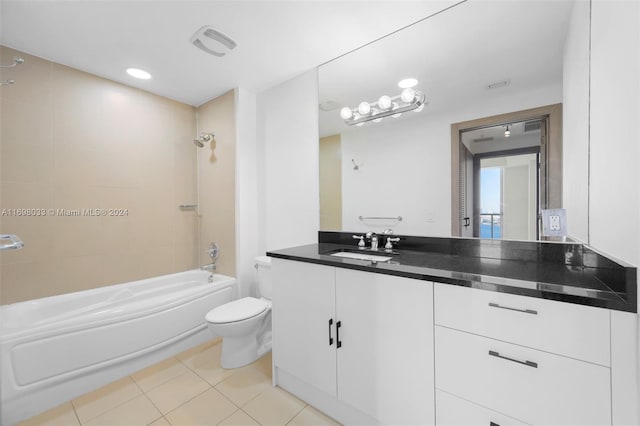 full bathroom with vanity, tile patterned flooring, tiled shower / bath, and toilet