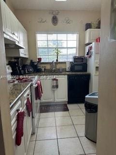 kitchen with white cabinets, light tile patterned flooring, sink, and black appliances