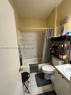 full bathroom featuring tile patterned floors, vanity, shower / bathtub combination with curtain, and toilet