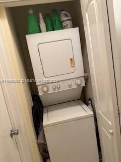 washroom featuring stacked washer / dryer