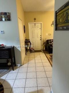 hall with light tile patterned flooring