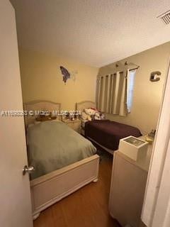 bedroom with dark wood-type flooring