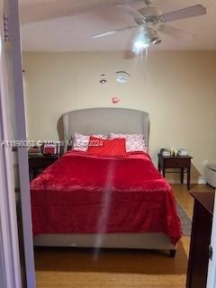 bedroom with hardwood / wood-style flooring and ceiling fan