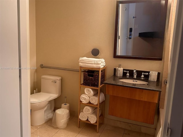 bathroom with tile patterned flooring, vanity, and toilet