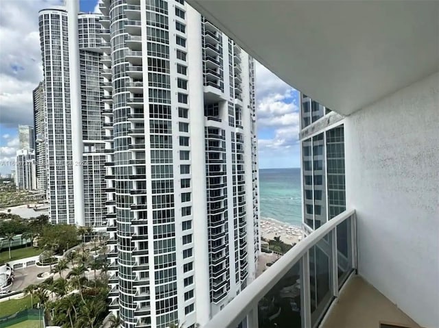 view of property with a water view and a view of the beach