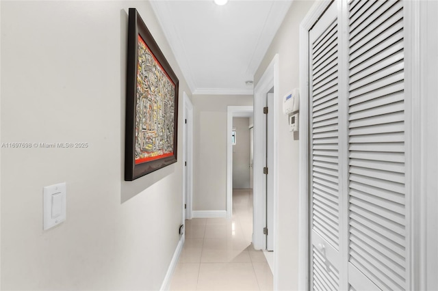 hall with light tile patterned floors and ornamental molding