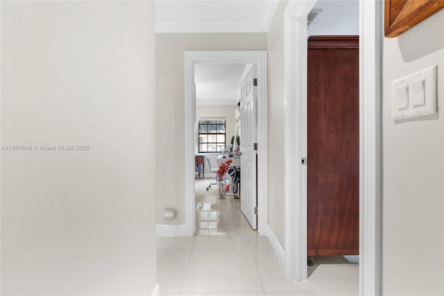 hallway featuring crown molding and light tile patterned flooring