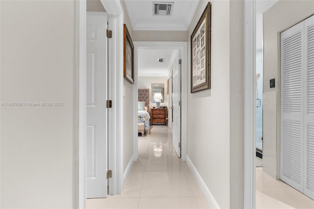 corridor featuring crown molding and light tile patterned flooring