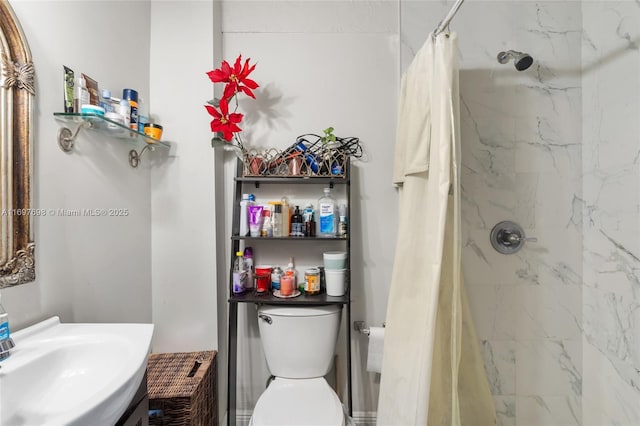 bathroom featuring toilet, sink, and a shower with shower curtain