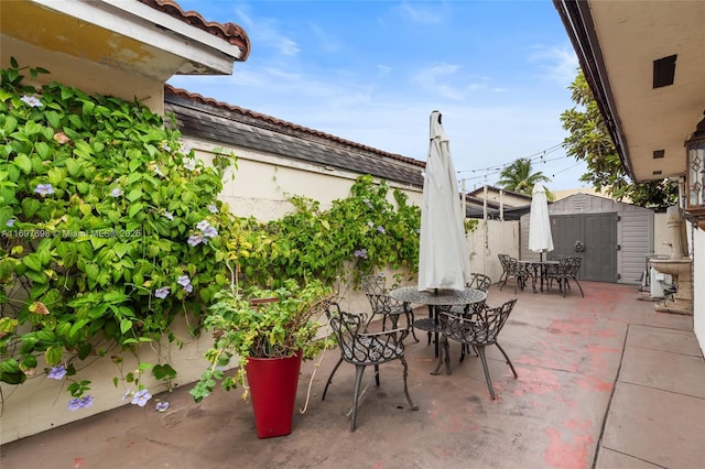 view of patio / terrace featuring a storage unit