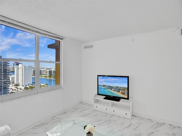 unfurnished living room with a textured ceiling and a wall of windows